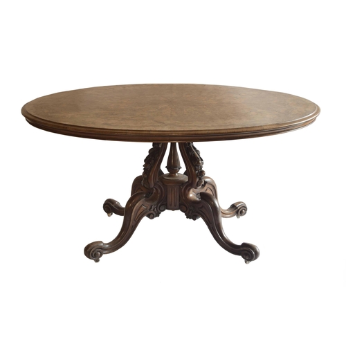 1821 - Victorian figured walnut oval breakfast/loo table, the decorative deep carved column with four scrol... 