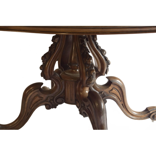 1821 - Victorian figured walnut oval breakfast/loo table, the decorative deep carved column with four scrol... 