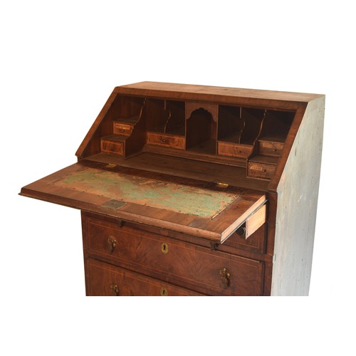 1765 - George II walnut and feather banded bureau, the fall front enclosing a fitted interior with a well, ... 