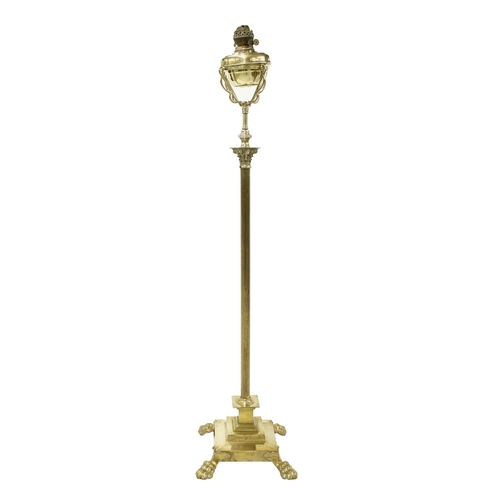 1068 - Polished brass Corinthian column standard oil lamp, the oil reserve in a basket mount upon a cast co... 