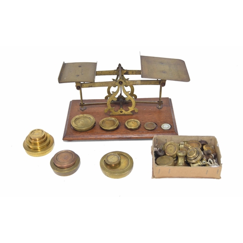 1362 - Set of Victorian brass and oak counter-top postal scales, inscribed with rates of postage, 11