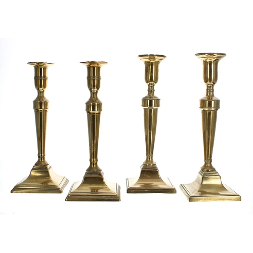 1193 - Pair of 18th century brass candlesticks, with tapered cylindrical columns upon square bases, 10