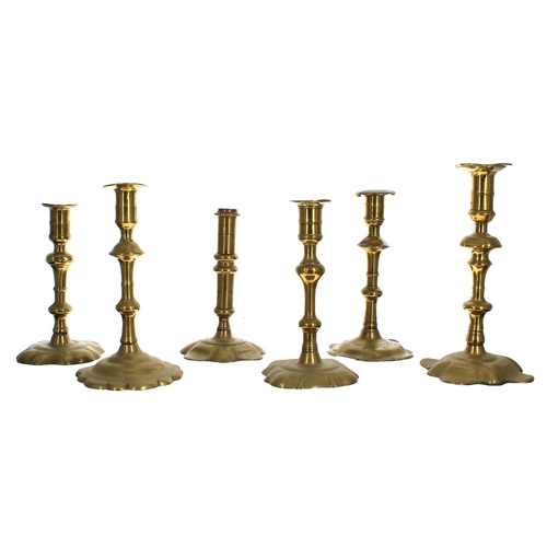 1151 - Six assorted 18th century petal base single brass candlesticks, 7.25