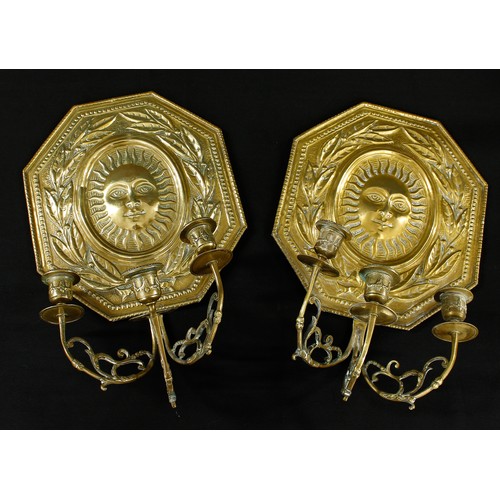 1005 - Pair of decorative Dutch repoussé brass triple sconce wall candelabra, the octagonal backs depicting... 