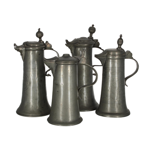 1200 - Four continental 18th/19th century lidded pewter flagons, one with wriggle decoration, the tallest 1... 