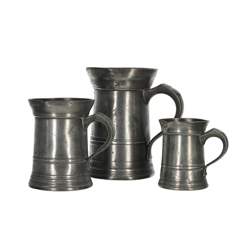 1201 - Graduated set of three pewter measures, with  reeded bodies, to include quart, pint and half pint, t... 