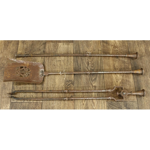 1220 - Set of three 19th century steel fire irons, with baluster turned stems, the shovel 30” long... 