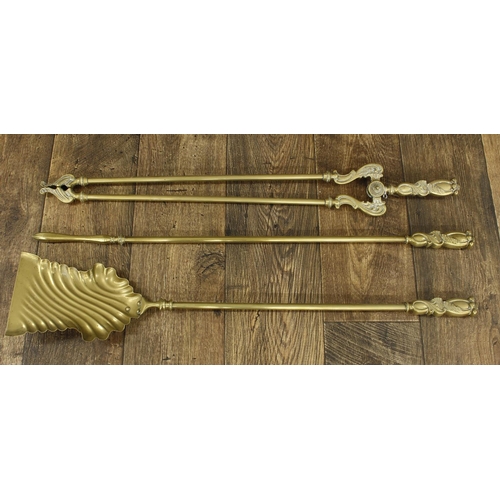 1347 - Ornate set of brass fire irons, with stylised cast handles, the shovel 31” long (3)