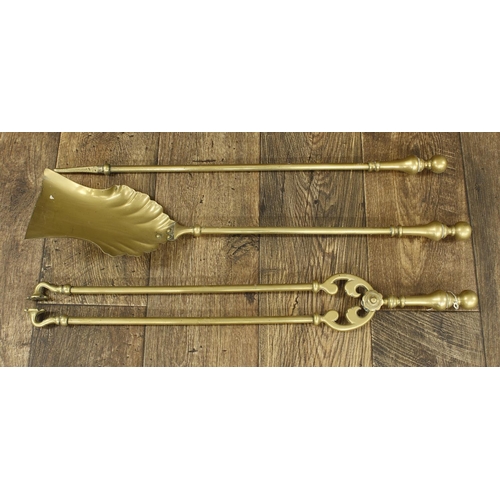 1055 - Set of three Victorian brass fire irons, with turned handles, the shovel 26.25” long (3)... 