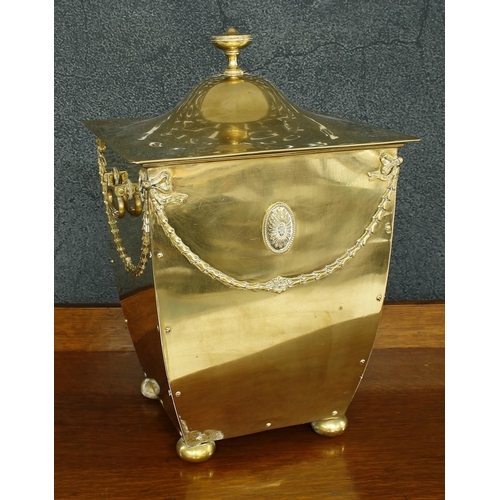 1184 - Neoclassic style polished brass square fireside log bin of tapered form with an urn finial, swing si... 