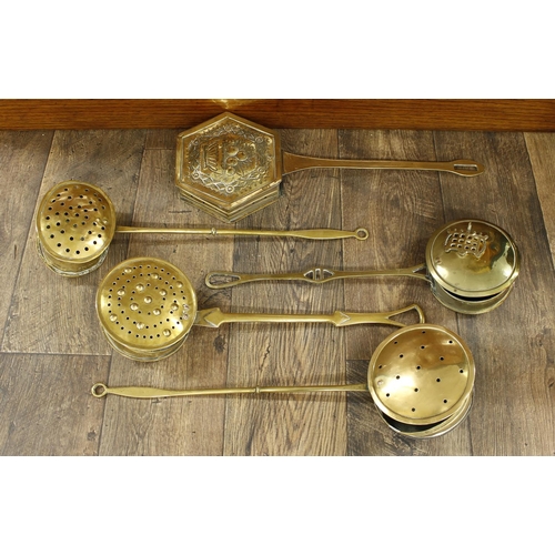 1141 - Five Victorian brass chestnut roasters, including a repousse example decorated with a bowl of fruit ... 