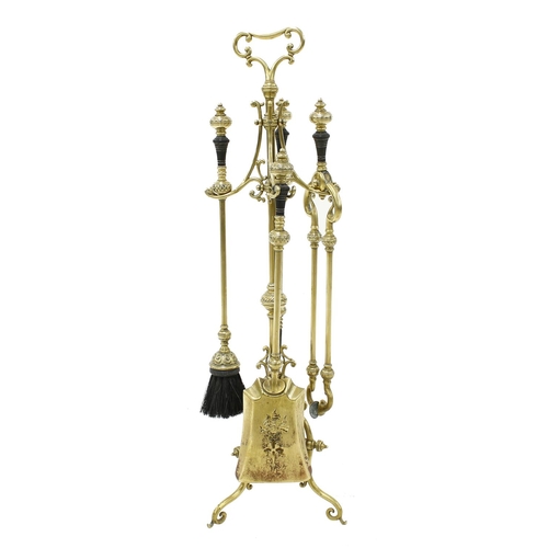 1208 - Late 19th century brass fire companion set, with ebony turned handles comprising a brush, poker, ton... 