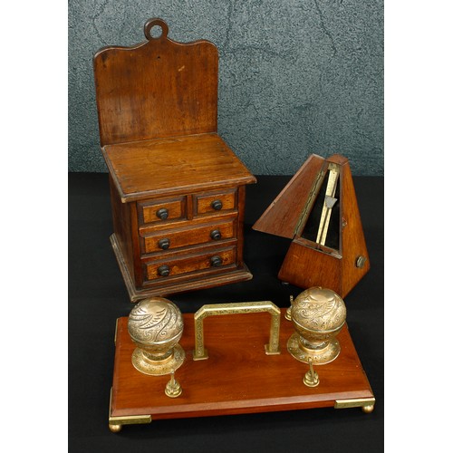 1042 - Mahogany and brass mounted desk inkstand, with applied carry-handle flanked with a pair of spherical... 