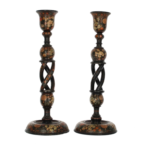 1106 - Pair of Kashmiri papier maché candlesticks, the open barley twist supports decorated with flowers, 1... 