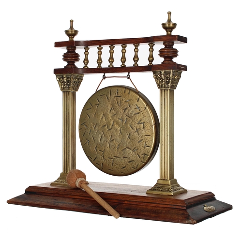 1067 - Early 20th century oak and brass dinner gong on stand, the stand with a turned brass gallery upon sq... 