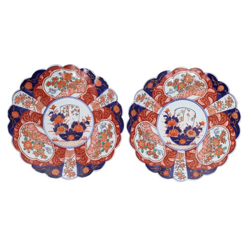 1585 - Pair of Japanese Imari porcelain chargers with fluted rims, decorated in typical palette, 13.25” dia... 