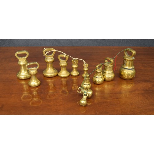 1367 - Graduated set of brass bell weights, 4lb through to 2oz; together with a matched set of four bell we... 