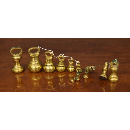 1366 - Graduated set of five Victorian brass bell weights, 2lb through to 2oz; together with a graduated cl... 