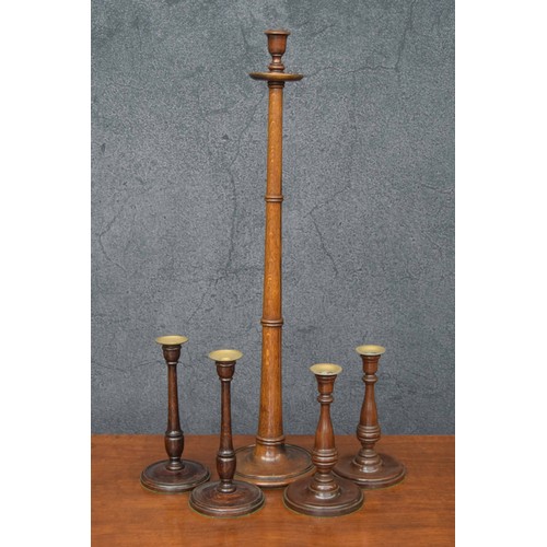 1206 - Tall antique oak candlestick, with ring turned support over a turned base, 31