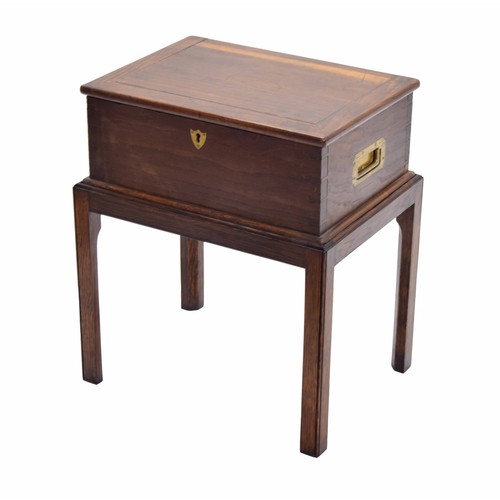 1084 - Oak and elm box on stand, with recessed brass side carry-handles and hinged top with an open interio... 