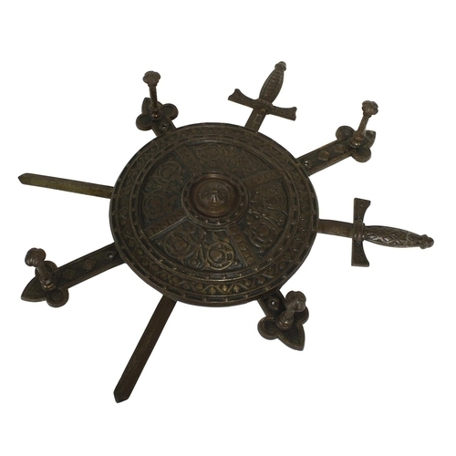 1271 - Decorative sword and shield cast iron hat and coat wall rack, modelled as a circular shield with swo... 