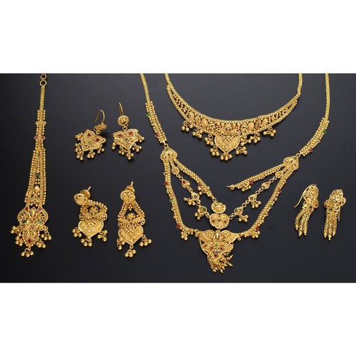 93 - Two yellow metal collars, an attachment and three pairs of earrings, 83.5gm (ref.204)... 