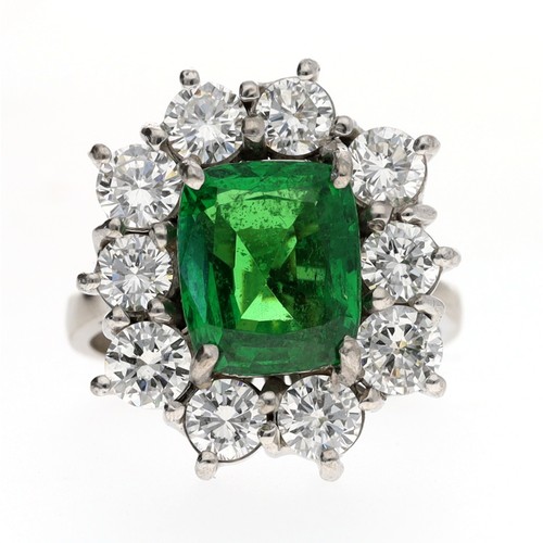 152 - Large fancy white metal diamond and green stone set cluster ring, with a border consisting of ten ro... 