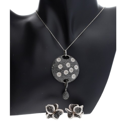 161 - Black and white diamond circular pendant on an 18ct white gold necklet, the pendant 65mm x 36mm; wit... 