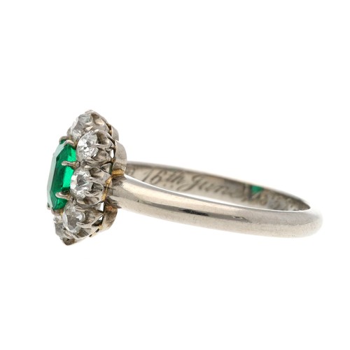 56 - Attractive period emerald and diamond white metal cluster ring, the emerald 0.60ct approx, in a surr... 