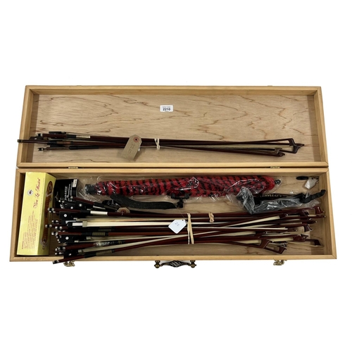 2210 - Large bundle of modern violin and viola bows; also a small bundle of older bows and three chin rests... 