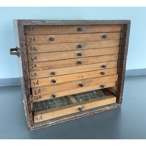 484 - Eleven drawer wooden chest containing a large quantity of watch parts including staffs and stems, in... 