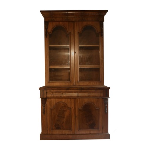 1782 - Large Victorian mahogany library bookcase, with arched glazed double doors enclosing shelves, the ba... 