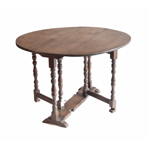 1812 - Antique oval oak low occasional gateleg side table, with turned supports united by a plank undertier... 