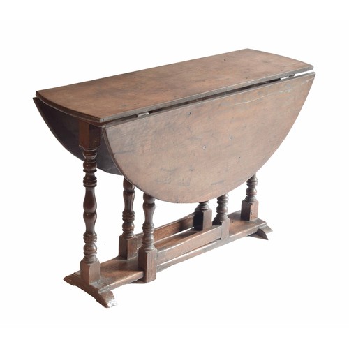 1812 - Antique oval oak low occasional gateleg side table, with turned supports united by a plank undertier... 