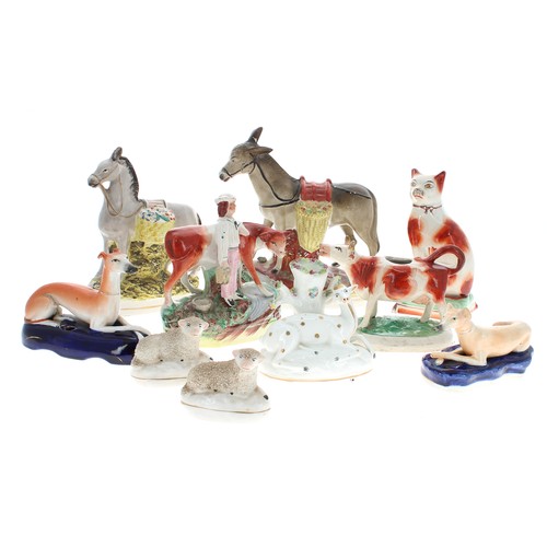 1557 - Collection of Victorian Staffordshire animal figures to include two greyhounds, cow creamer, two don... 