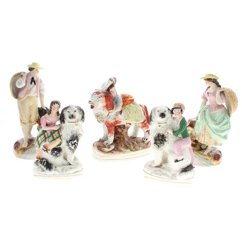 1555 - Pair of Victorian Staffordshire pottery dogs, with black and white coats, modelled with children, 7”... 