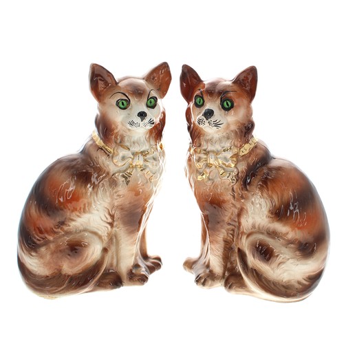 1562 - Pair of Sadler Staffordshire pottery seated cats, with set eyes and gilded bow collars, 13” high; to... 