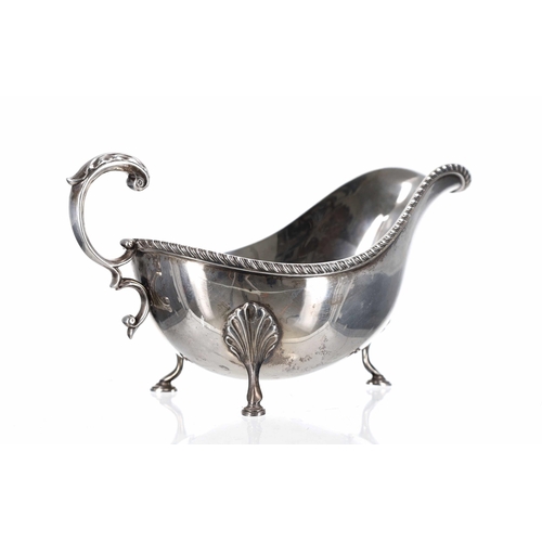 502 - Barker Brothers Silver Ltd silver sauce boat, cast gadrooned rim border, leaf capped C scroll handle... 