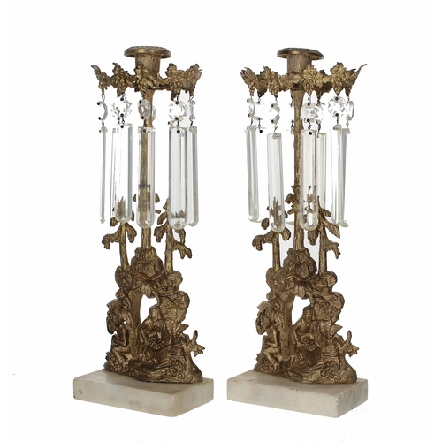 575 - Pair of Victorian ormolu and glass lustre candlesticks, the bases cast with figures by an arch under... 