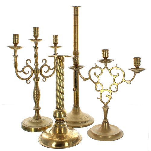 1028 - Tall 18th century brass single candlestick with a side ejector upon a circular base, 20