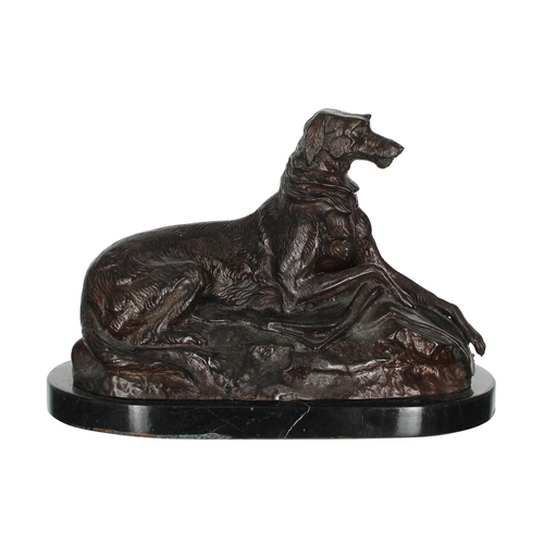 578 - After Rosa Bonheur (French 1822-1899) - a spelter metal figural study of a hound resting on a natura... 