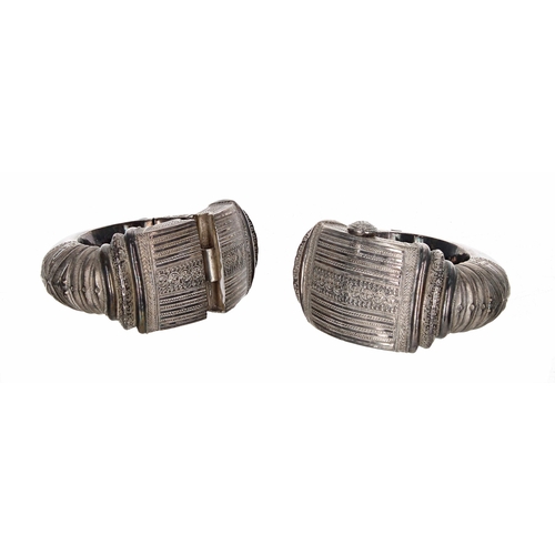 636 - Pair of Oman Bedouin white metal ankle bangles, each with a textured finish, 24oz t in total (one la... 