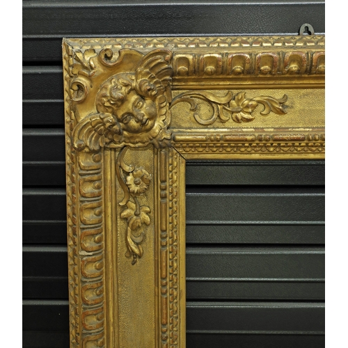 734 - Large ornate giltwood and gesso frame, the corners with winged putti, 44