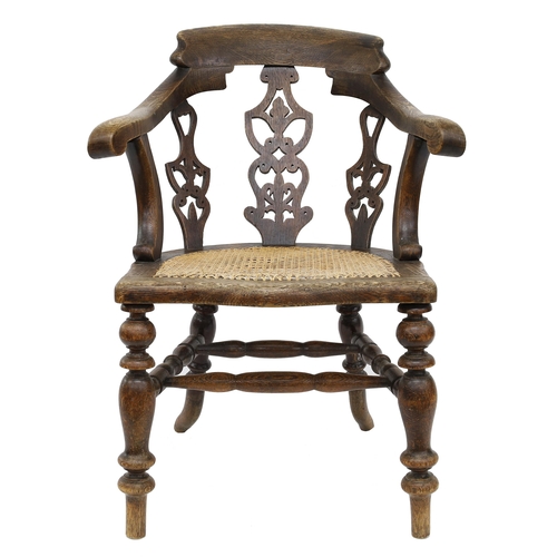 801 - Oak captain's armchair, the curved back with three pierced splats over a bergere seat upon turned le... 