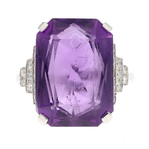 52 - Impressive platinum amethyst dress ring set with diamonds in a stepped stylised setting, the amethys... 