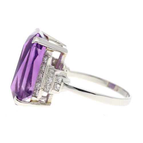 52 - Impressive platinum amethyst dress ring set with diamonds in a stepped stylised setting, the amethys... 