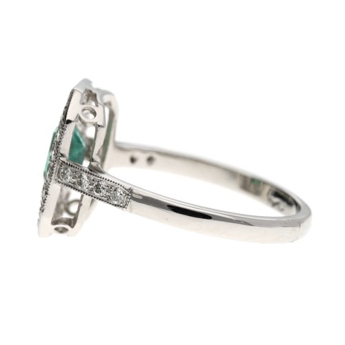 72 - Attractive platinum emerald and diamond cluster ring, the emerald 0.6ct approx, in a rectangular set... 