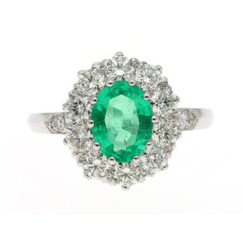 122 - Good platinum emerald and diamond oval cluster ring, the emerald 1.10ct approx, in a border of round... 