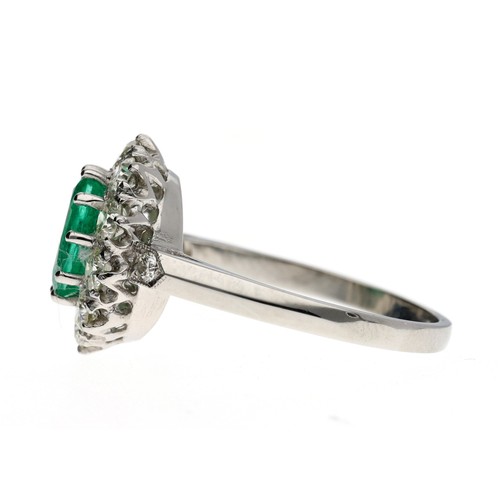 122 - Good platinum emerald and diamond oval cluster ring, the emerald 1.10ct approx, in a border of round... 