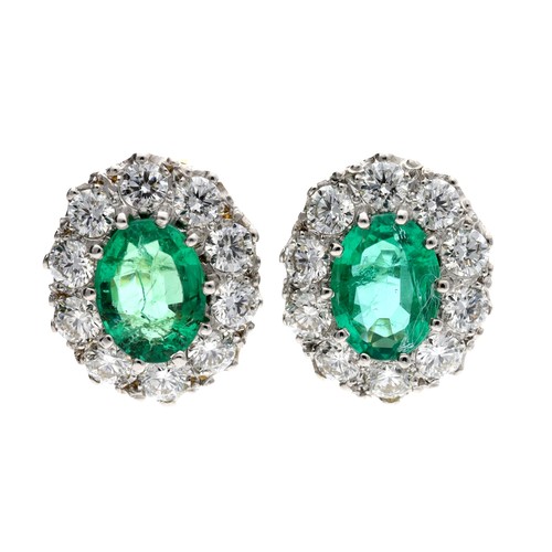 172 - Attractive pair of 18ct emerald and diamond oval cluster earrings, with oval emeralds each estimated... 